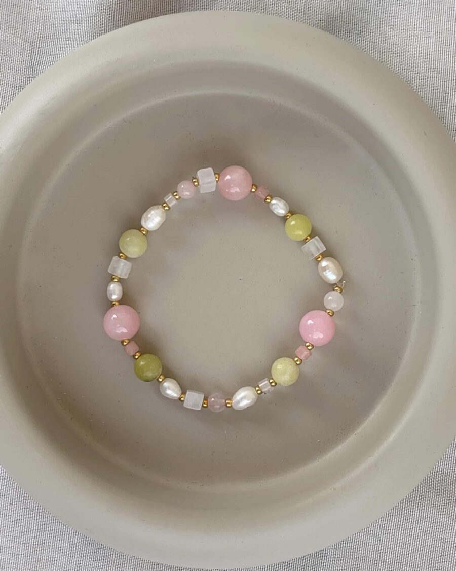 Rosa grünes Armband auf grauem hintergrund
